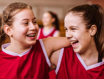 two girls playing basketball